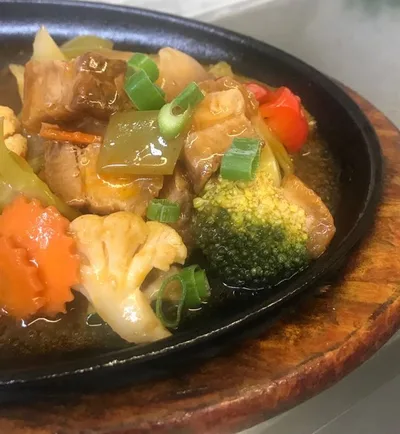 Crispy pork dish on a wooden table