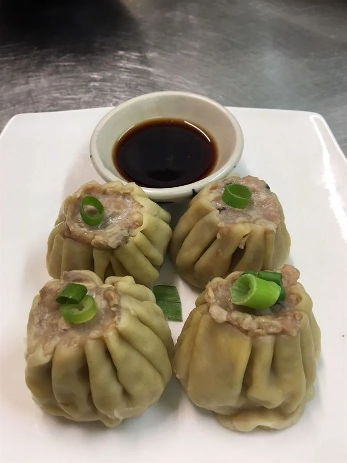 Steamed pork dumplings with dipping sauce