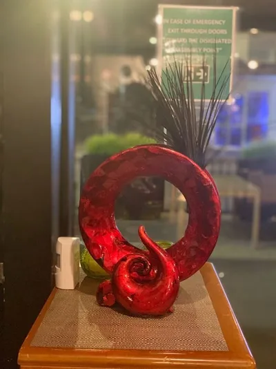 Red sculpture on a wooden table